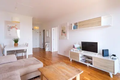 a living room with a couch and a flat screen tv at GuestReady - Marvellous ocean view in Caniço in Caniço