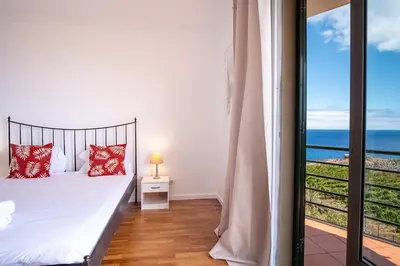 a bedroom with a bed and a view of the ocean at GuestReady - Marvellous ocean view in Caniço in Caniço