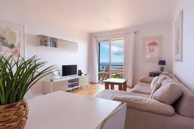 a living room with a couch and a table at GuestReady - Marvellous ocean view in Caniço in Caniço