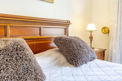 a bedroom with a bed with two pillows on it at Ocean Lido in Funchal