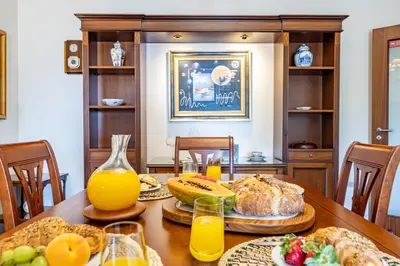 a table with bread and orange juice and fruit on it at Ocean Lido in Funchal