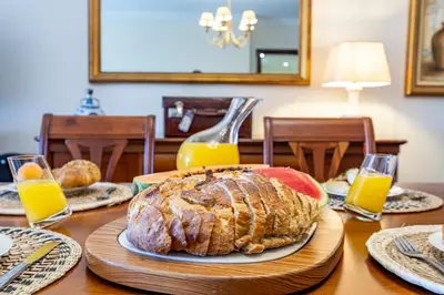a table with a large loaf of bread and orange juice at Ocean Lido in Funchal