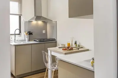 a kitchen with white counters and a sink and a stove at Cozy Apartments by Homie in Porto Moniz