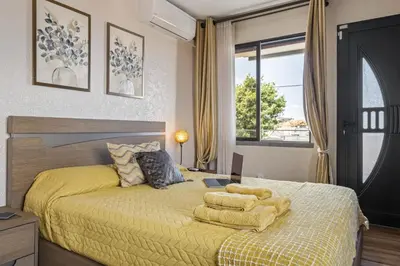 a bedroom with a yellow bed with a yellow comforter at Cozy Apartments by Homie in Porto Moniz