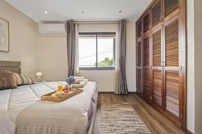 a bedroom with a large bed with a tray on it at Cozy Apartments by Homie in Porto Moniz