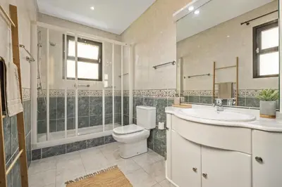 a bathroom with a toilet and a sink and a shower at Cozy Apartments by Homie in Porto Moniz