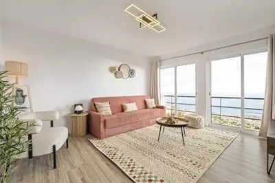 a living room with a pink couch and a table at Skyline Heights by Homie in Funchal