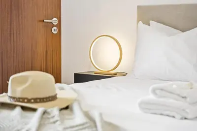 a bedroom with a bed with a hat and a mirror at Skyline Heights by Homie in Funchal