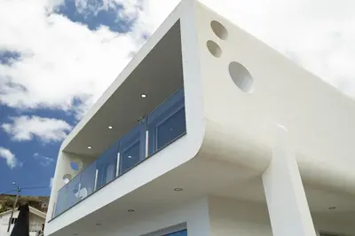 a white building with windows on the side of it at Villa Althea by YMR in Calheta