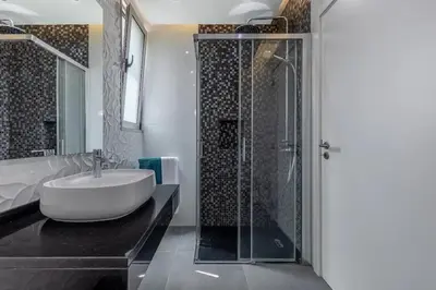 a bathroom with a sink and a shower at Villa Althea by YMR in Calheta