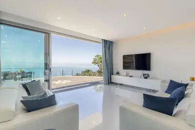 a living room with a view of the ocean at Villa Althea by YMR in Calheta