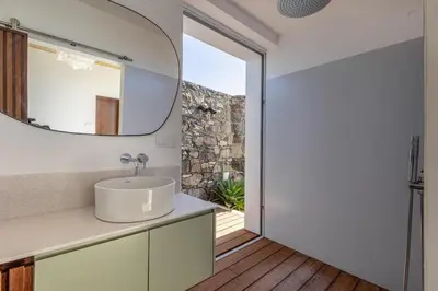 a fire pit with the ocean in the background at Terraços da Calheta by YMR in Estreito da Calheta