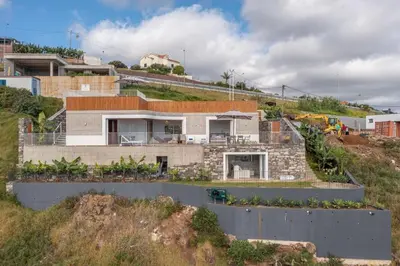 a bedroom with a bed with towels on it at Terraços da Calheta by YMR in Estreito da Calheta