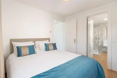 a living room with a blue couch and a staircase at OurMadeira - Chalet Prazeres in Prazeres