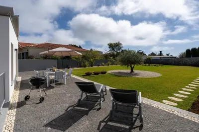a house with a blank sign in front of it at OurMadeira - Chalet Prazeres in Prazeres
