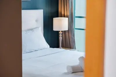 a bedroom with a white bed and a lamp at GuestReady - Sea breeze in Funchal in Funchal