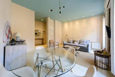 a living room with a glass table and white chairs at GuestReady - Sea breeze in Funchal in Funchal