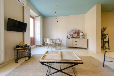 a living room with a table and a tv at GuestReady - Sea breeze in Funchal in Funchal