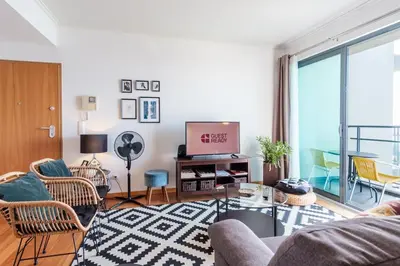 a living room with a couch and a tv at GuestReady - Sea breeze in Funchal in Funchal