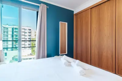 a bedroom with a bed and a large window at GuestReady - Sea breeze in Funchal in Funchal