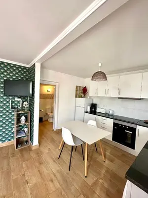 a kitchen and dining room with a table and chairs at Little Blue Paradise in Ribeira Brava