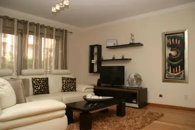 a living room with a couch and a tv at Apartamento Batista in Funchal