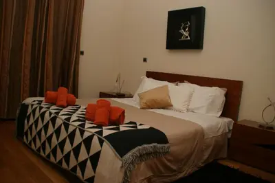two stuffed animals sitting on top of a bed at Apartamento Batista in Funchal
