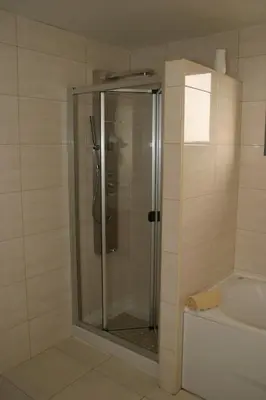 a shower with a glass door in a bathroom at Apartamento Batista in Funchal
