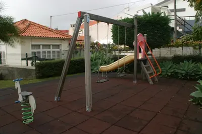 a playground with a slide and a slideintend at Apartamento Batista in Funchal