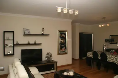 a living room with a couch and a tv at Apartamento Batista in Funchal