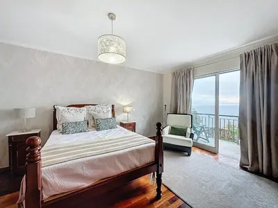 a bedroom with a bed and a balcony at Ocean View Botânico in Funchal