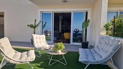 a patio with two chairs and a table and a tableablish at Ocean View Botânico in Funchal