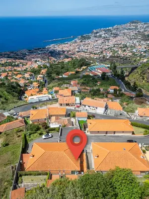 a view of a town with a red marker on its roofs at Ocean View Botânico in Funchal