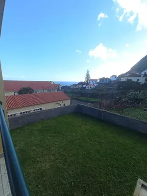 a view of a yard from a balcony at Village Sun House - Porto Moniz in Porto Moniz