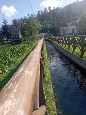 a bridge over a river with water at Village Sun House - Porto Moniz in Porto Moniz