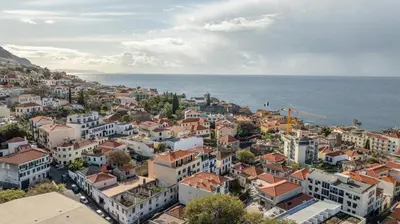 an aerial view of a town next to the ocean at Funchal pad with Harbor Views & cool Aircon Bliss in Funchal