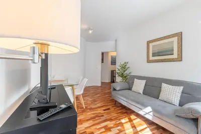 a living room with a couch and a table at Funchal pad with Harbor Views & cool Aircon Bliss in Funchal