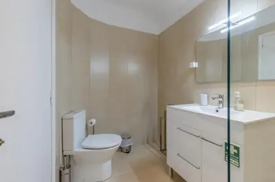 a bathroom with a toilet and a sink at Funchal pad with Harbor Views & cool Aircon Bliss in Funchal