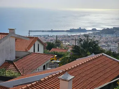 a view of the ocean from the roofs of houses at Bela Vista Funchal Villa in Funchal