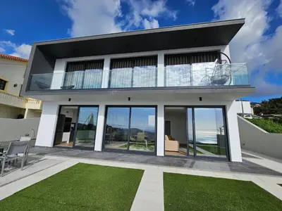 a house with a view of the ocean at Bela Vista Funchal Villa in Funchal