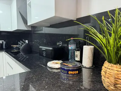 a kitchen counter with a bottle of water and a plant at Bela Vista Funchal Villa in Funchal