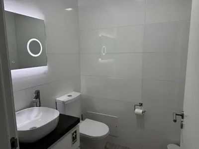 a white bathroom with a sink and a toilet at Bela Vista Funchal Villa in Funchal