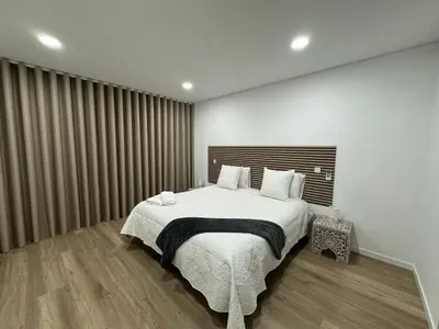 a bedroom with a large bed and a large window at Bela Vista Funchal Villa in Funchal