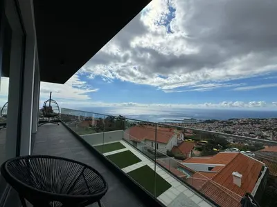a balcony of a house with a view of the ocean at Bela Vista Funchal Villa in Funchal