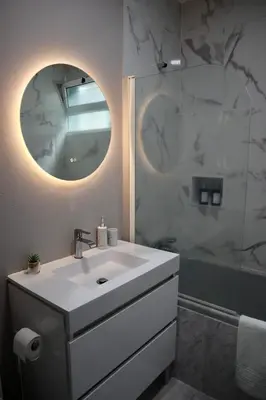 a white bathroom with a sink and a mirror at Faria's House 2 in Feiteiras