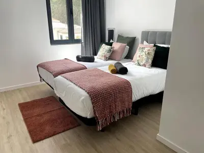 two beds with stuffed animals on them in a room at CGD São Vicente Apartments in São Vicente