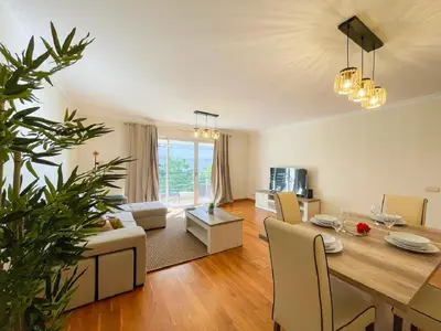 a dining room and living room with a table and chairs at Suite Elizabeth in Funchal