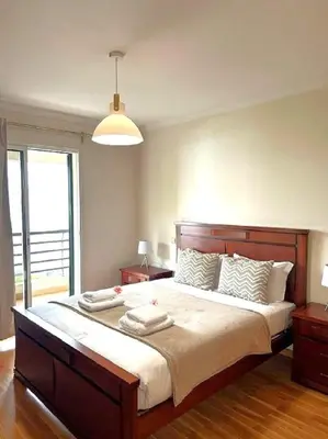 a bedroom with a large bed with two towels on it at Suite Elizabeth in Funchal