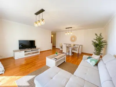 a living room with a white couch and a table at Suite Elizabeth in Funchal