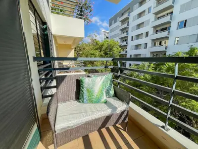 a balcony with a wicker chair on a building at Suite Elizabeth in Funchal